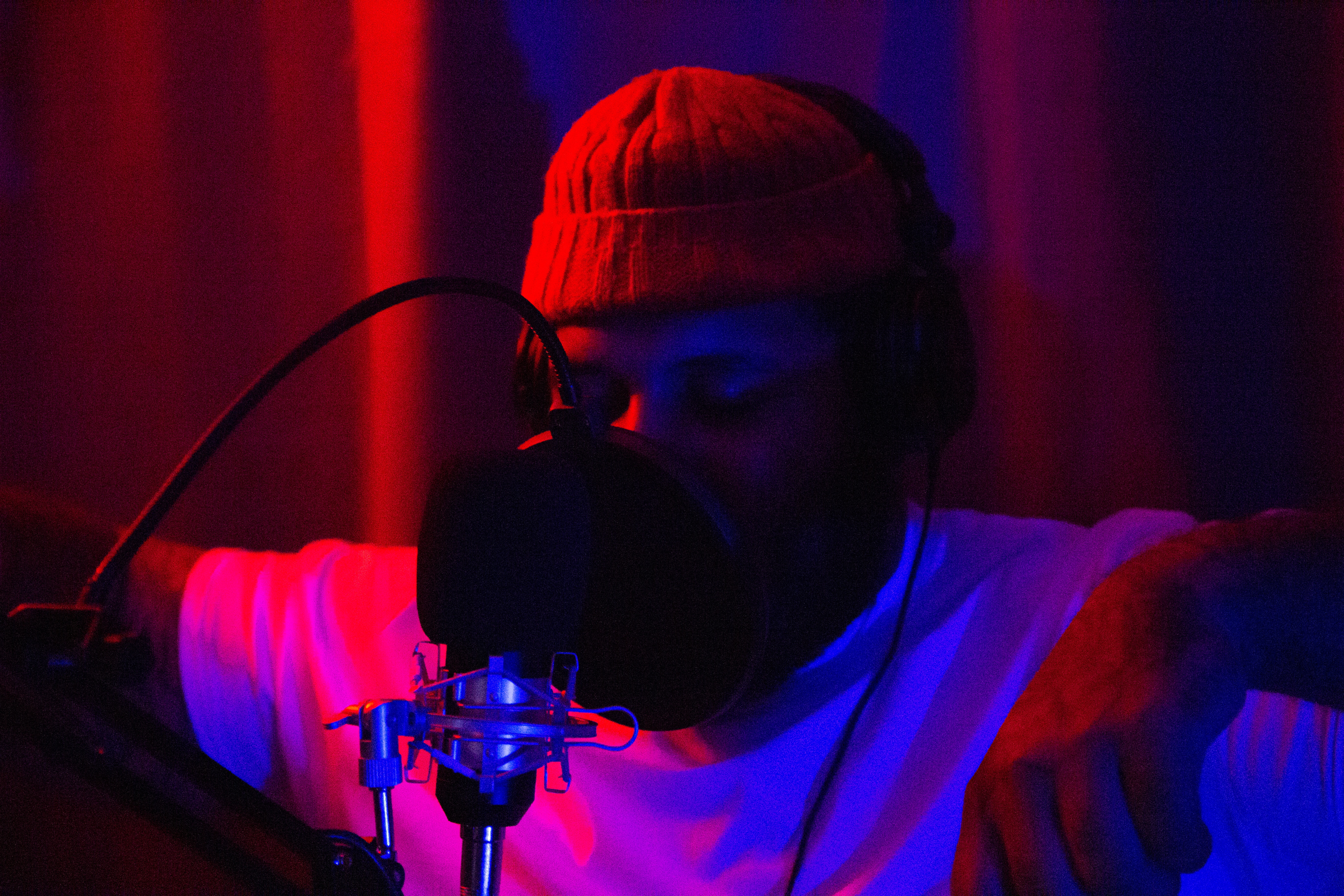 man in white shirt wearing black headphones